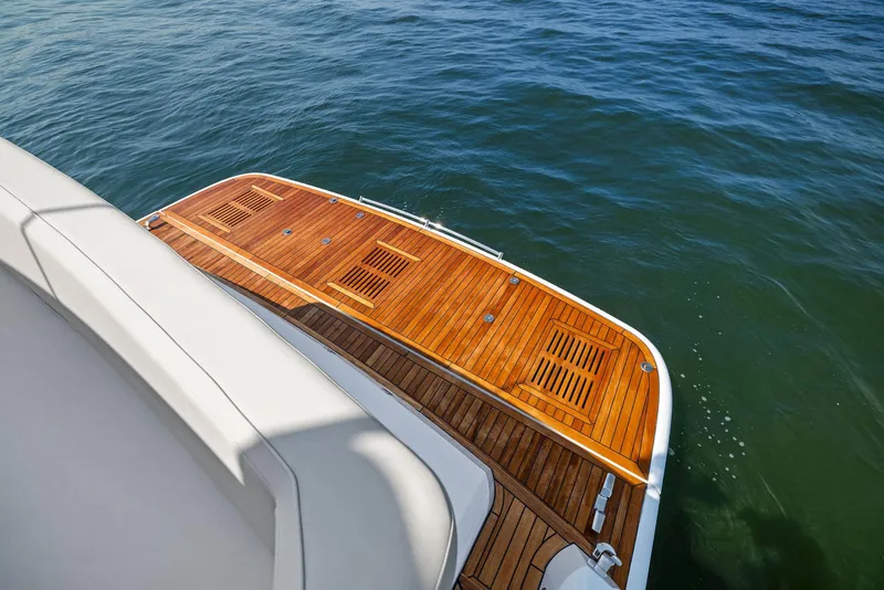 Slide: The Image of Fairline Targa 50 GT 2025 yacht with elegant wooden deck on calm water. - 15