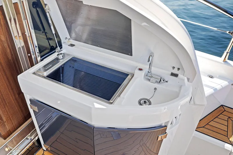 Slide: The Image of Outdoor kitchenette on 2025 Fairline Targa 50 GT yacht, featuring grill and sink. - 17