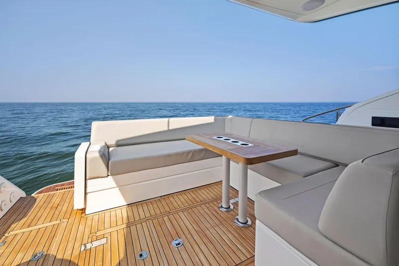 Slide: The Image of 2025 Fairline Targa 50 GT yacht deck with seating and ocean view. - 19