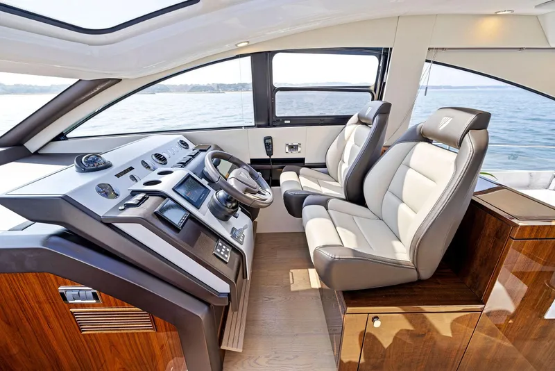 Slide: The Image of Interior of 2025 Fairline Targa 50 GT yacht, featuring modern helm and luxurious seating. - 27