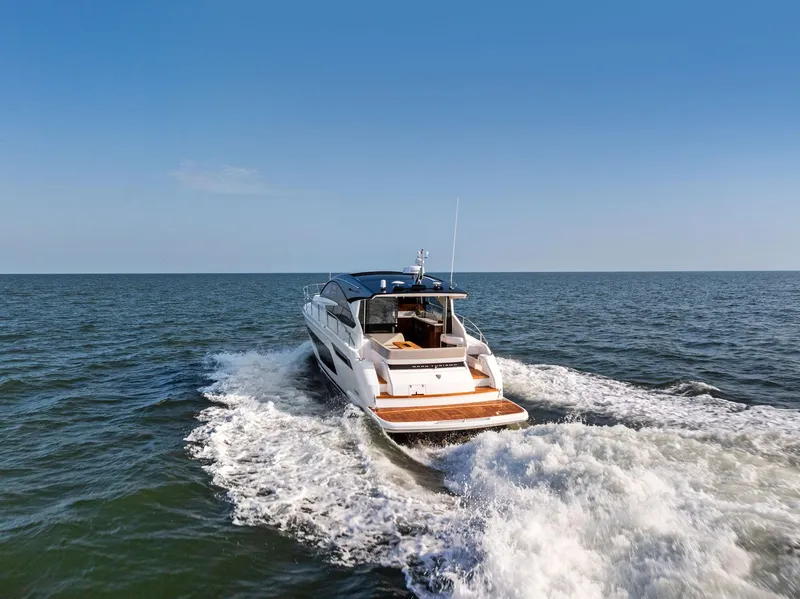 Slide: The Image of 2025 Fairline Targa 50 GT yacht cruising on open sea under clear blue sky. - 4