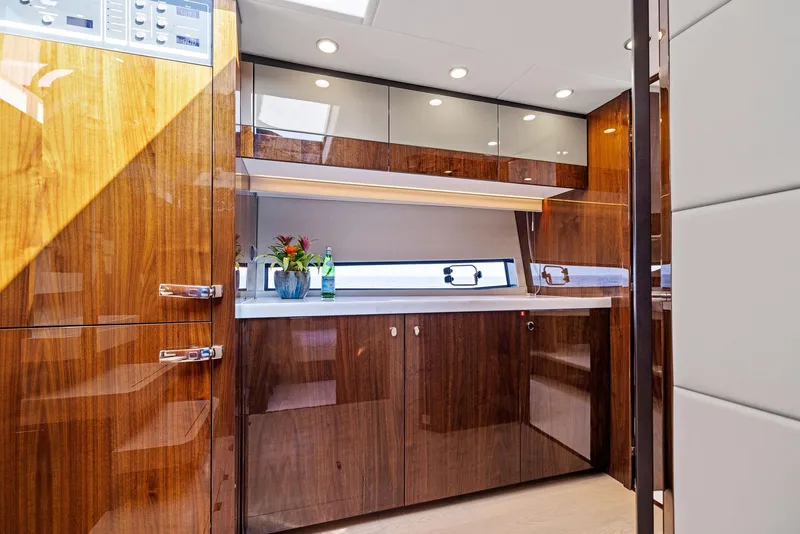 Slide: The Image of Luxurious 2025 Fairline Targa 50 GT yacht interior with sleek wood cabinetry and modern lighting. - 43