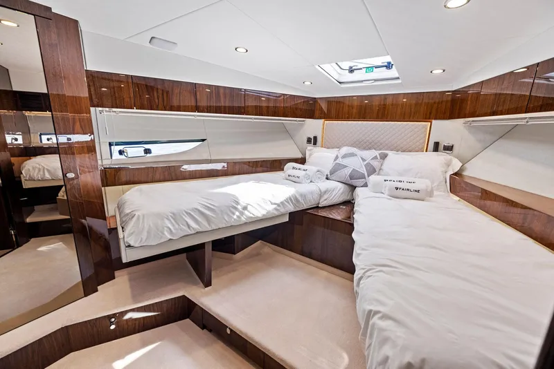 Slide: The Image of Luxurious cabin interior of 2025 Fairline Targa 50 GT yacht with twin beds and elegant wood finish. - 49