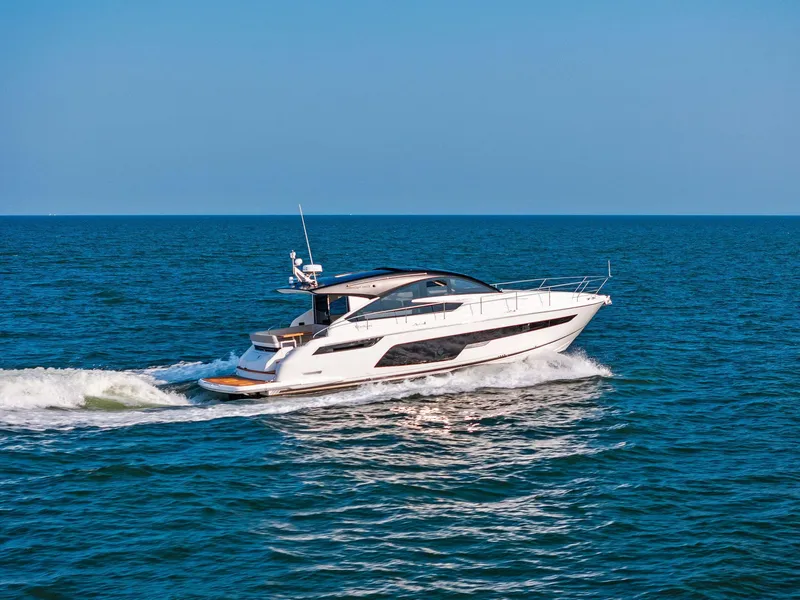 Slide: The Image of 2025 Fairline Targa 50 GT yacht cruising on open sea under clear blue sky. - 7