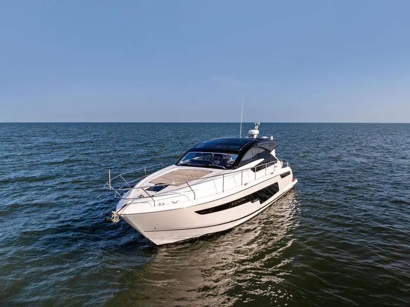 Slide: The Image of 2025 Fairline Targa 50 GT yacht cruising on open sea under clear blue sky. - 9