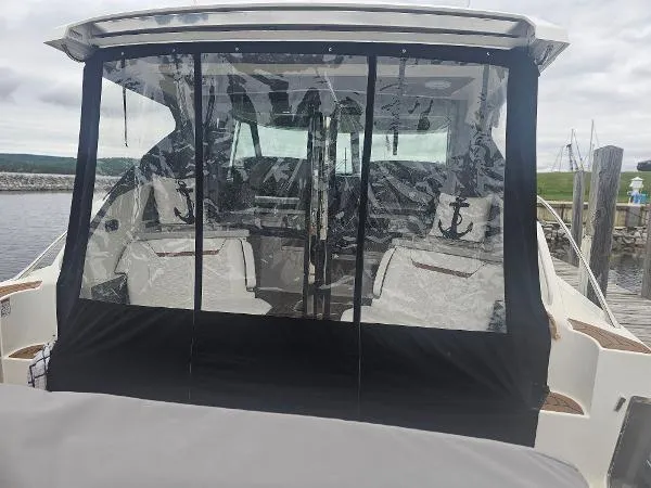 Slide: The Image of 2021 Tiara Sport 43 LE boat with enclosed cockpit at the dock. - 13