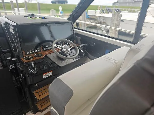 Slide: The Image of 2021 Tiara Sport 43 LE helm station with modern controls and dual displays. - 15