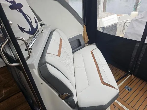 Slide: The Image of 2021 Tiara Sport 43 LE boat interior with white and brown seating. - 17