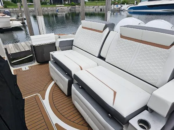 Slide: The Image of 2021 Tiara Sport 43 LE luxury boat seating area with white and brown upholstery. - 19