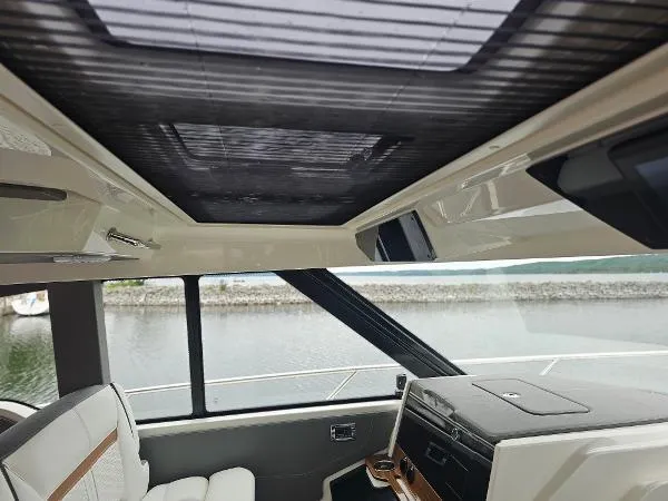 Slide: The Image of Interior view of 2021 Tiara Sport 43 LE yacht with panoramic windows. - 22