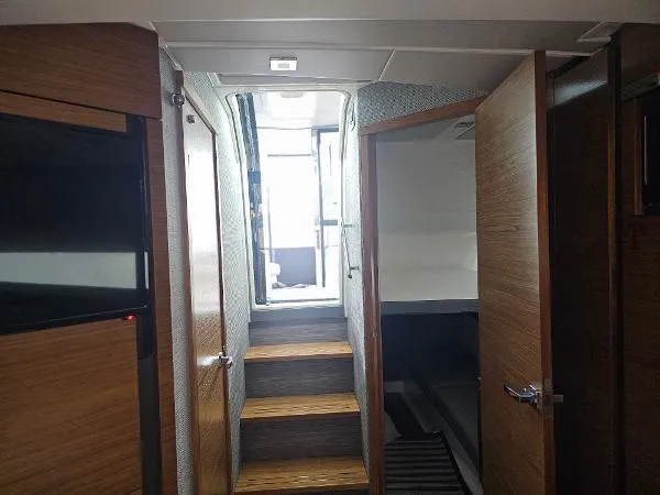 Slide: The Image of Interior view of 2021 Tiara Sport 43 LE yacht with wooden steps and doors. - 23