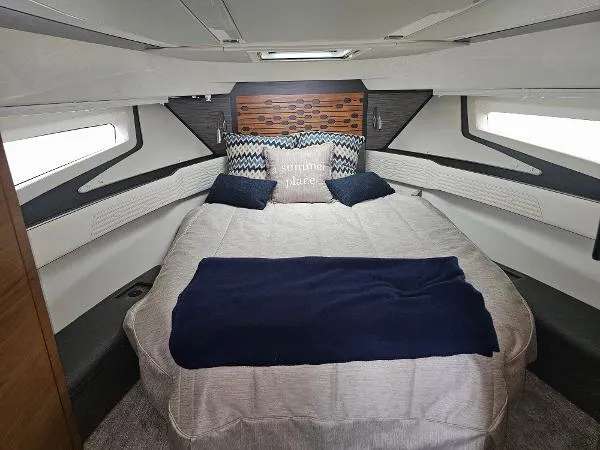 Slide: The Image of 2021 Tiara Sport 43 LE cabin with cozy bed and decorative pillows. - 25