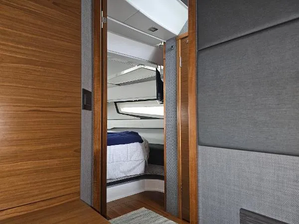 Slide: The Image of Interior cabin view of 2021 Tiara Sport 43 LE yacht, featuring modern wood and fabric finishes. - 28