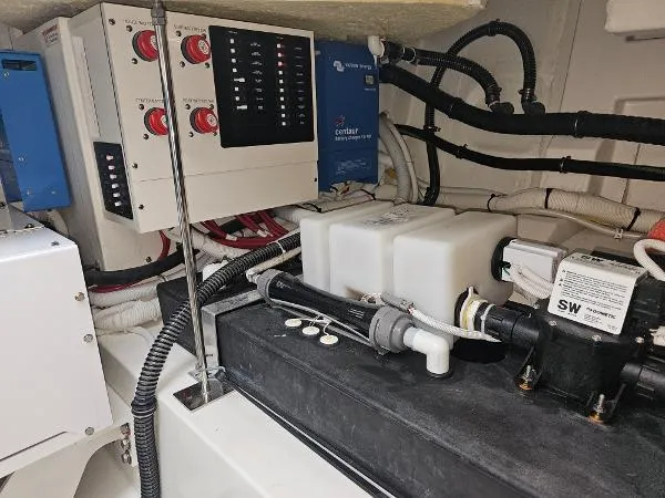 Slide: The Image of 2021 Tiara Sport 43 LE engine room with electrical and plumbing systems. - 32