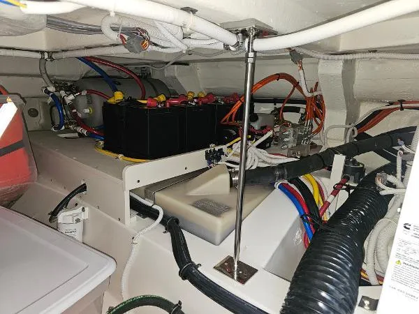 Slide: The Image of Engine compartment of a 2021 Tiara Sport 43 LE boat with wiring and battery setup. - 33