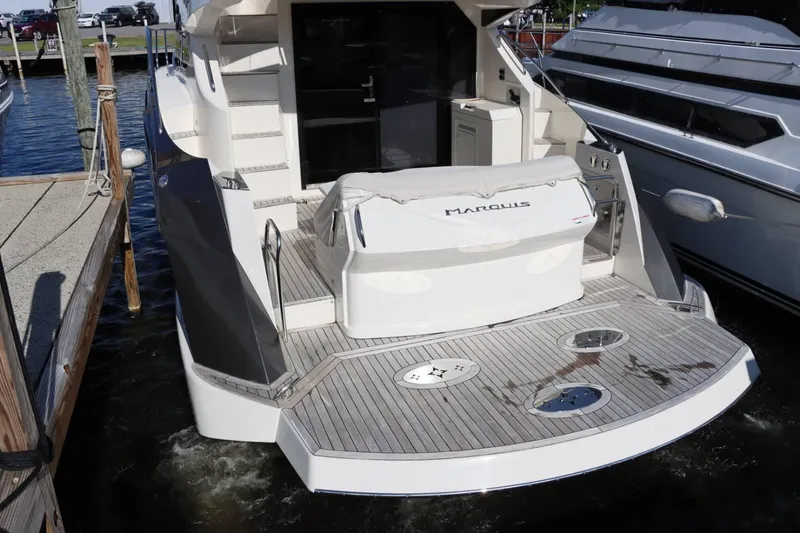 Slide: The Image of 2014 Marquis 42 Sport Bridge yacht stern view at dock. - 10