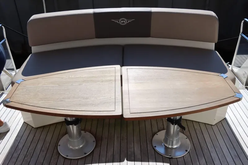 Slide: The Image of 2014 Marquis 42 Sport Bridge yacht seating area with wooden table. - 12