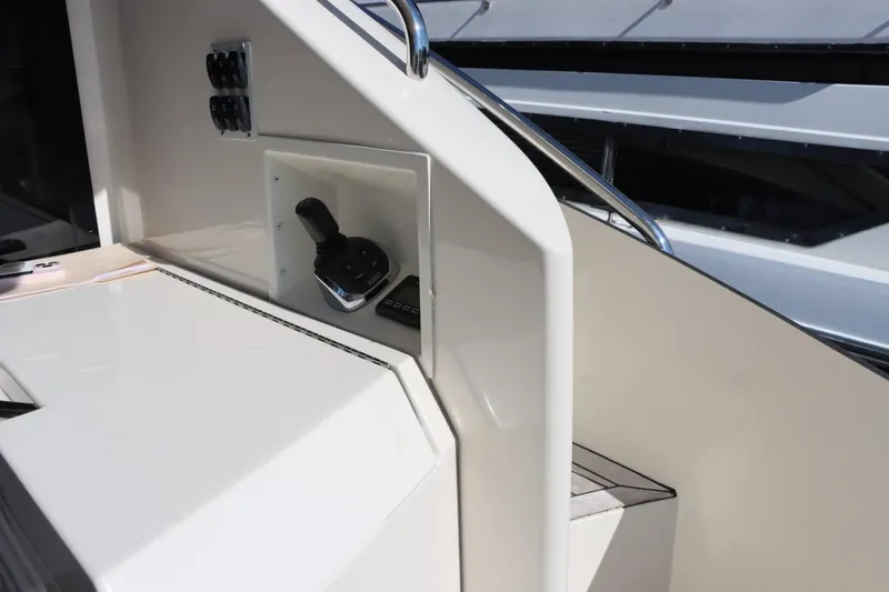 Slide: The Image of Control panel of a 2014 Marquis 42 Sport Bridge yacht with joystick and switches. - 14