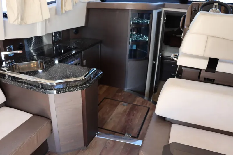 Slide: The Image of Interior of 2014 Marquis 42 Sport Bridge yacht with modern kitchen and seating area. - 22