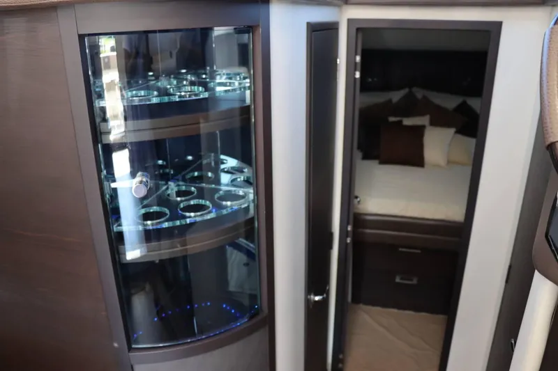 Slide: The Image of Interior of 2014 Marquis 42 Sport Bridge yacht with glass cabinet and bedroom. - 24