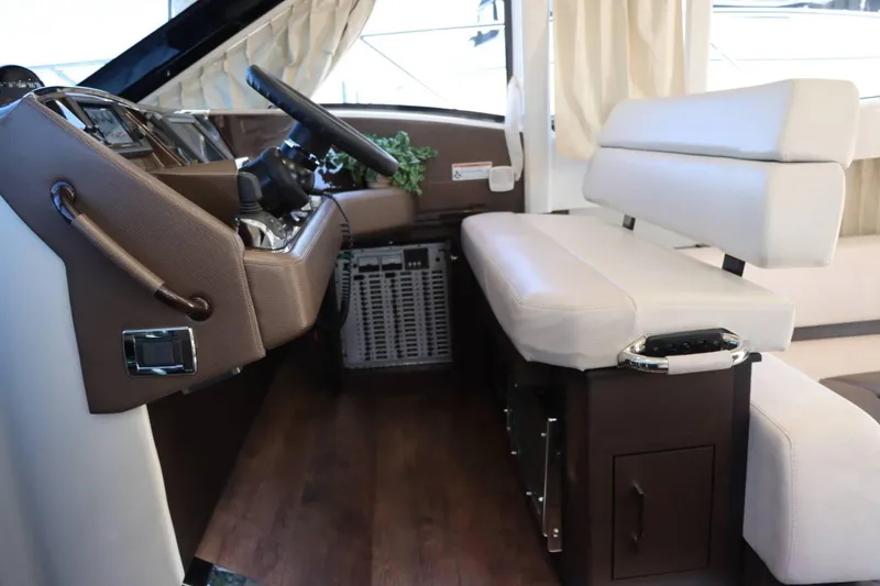 Slide: The Image of Interior helm of 2014 Marquis 42 Sport Bridge yacht with leather seating and modern controls. - 26