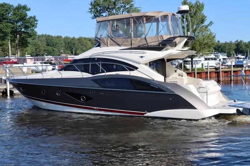 Slide: The Image of 2014 Marquis 42 Sport Bridge yacht docked in a marina. - 3