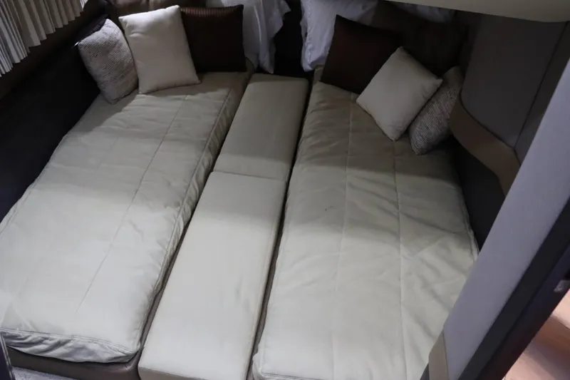 Slide: The Image of Twin beds with beige bedding and pillows in a 2014 Marquis 42 Sport Bridge yacht. - 30