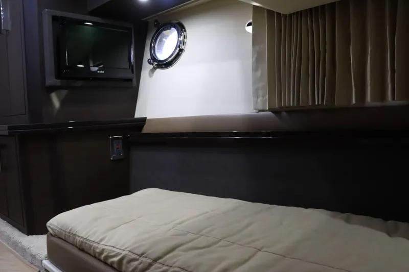 Slide: The Image of Interior cabin of 2014 Marquis 42 Sport Bridge with bed, TV, and porthole window. - 31