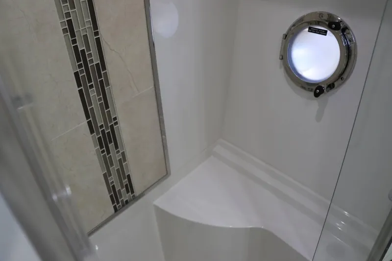 Slide: The Image of Bathroom interior of 2014 Marquis 42 Sport Bridge yacht with porthole and tiled wall. - 33