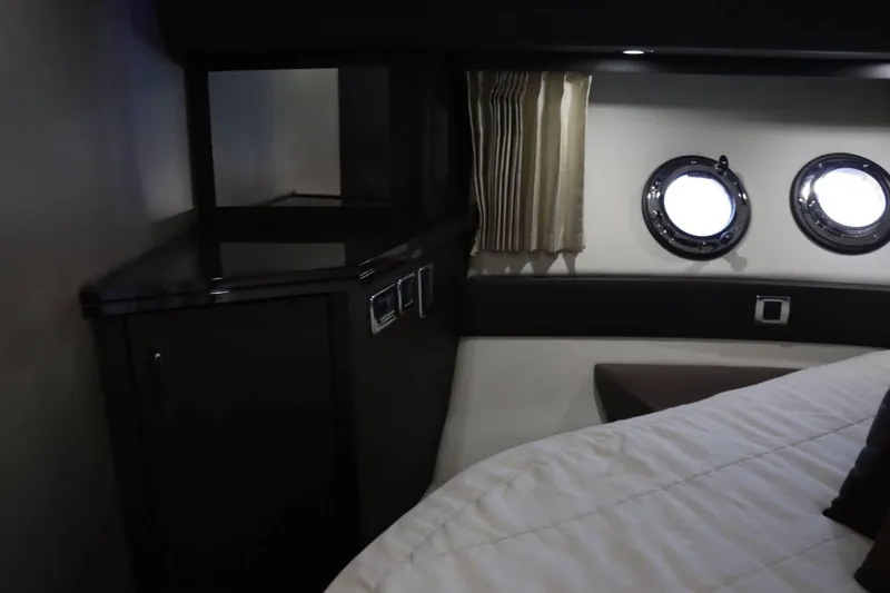 Slide: The Image of Interior cabin of 2014 Marquis 42 Sport Bridge yacht with porthole windows and cabinetry. - 36