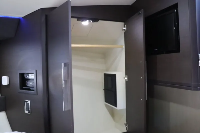 Slide: The Image of Interior closet of 2014 Marquis 42 Sport Bridge yacht with dark wood finish. - 37
