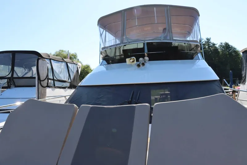 Slide: The Image of 2014 Marquis 42 Sport Bridge yacht with sun loungers and covered flybridge. - 40