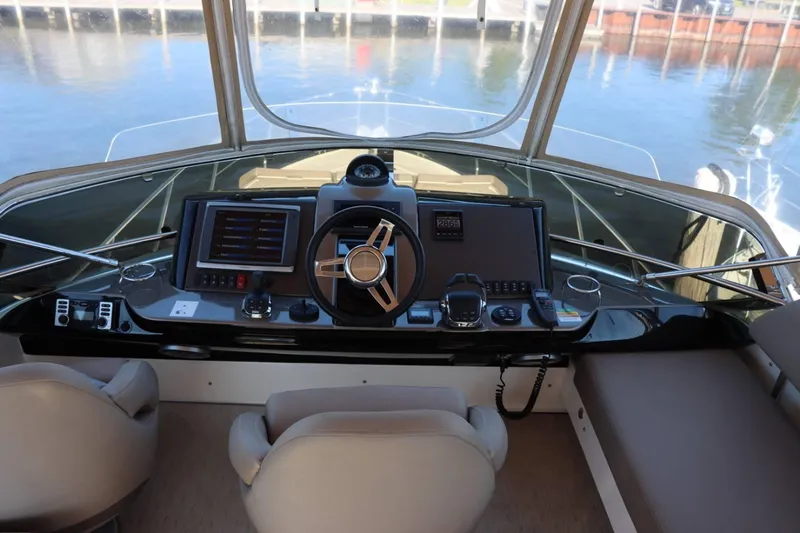 Slide: The Image of Helm station of 2014 Marquis 42 Sport Bridge yacht with modern navigation equipment. - 42