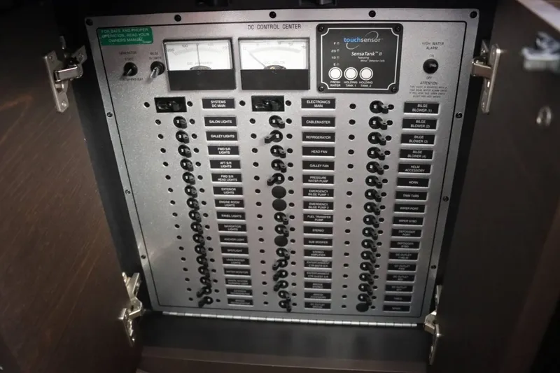 Slide: The Image of Control panel of a 2014 Marquis 42 Sport Bridge yacht with various switches and gauges. - 44