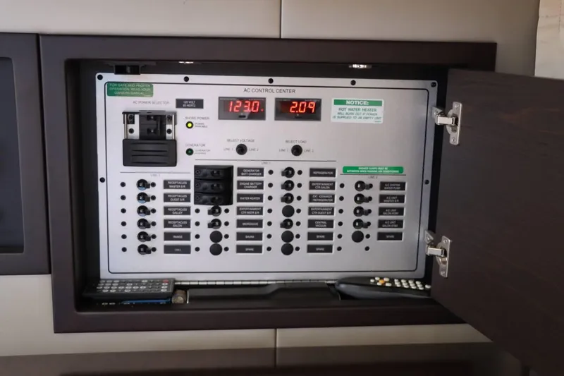 Slide: The Image of 2014 Marquis 42 Sport Bridge AC control center panel with various switches and indicators. - 45