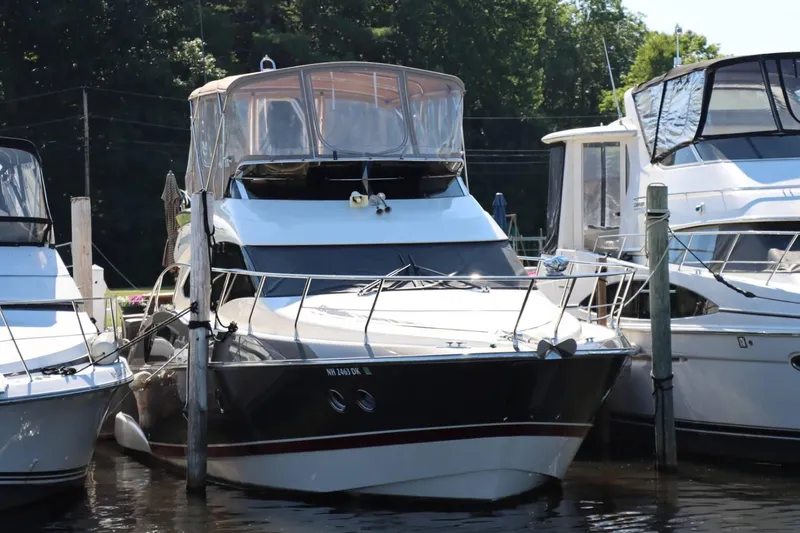 Slide: The Image of 2014 Marquis 42 Sport Bridge yacht docked at marina. - 7