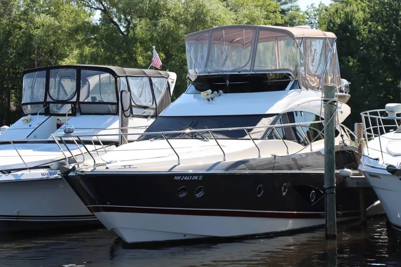 Slide: The Image of 2014 Marquis 42 Sport Bridge yacht docked at marina. - 9
