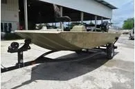 Slide: The Image of 2024 Tracker Grizzly 1754 SC boat on a trailer in an outdoor setting. - 12