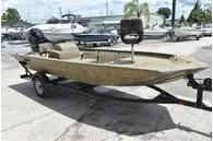 Slide: The Image of 2024 Tracker Grizzly 1754 SC fishing boat on a trailer in a marina. - 5