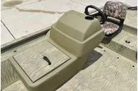 Slide: The Image of 2024 Tracker Grizzly 1754 SC boat interior with steering console and camo seat. - 8