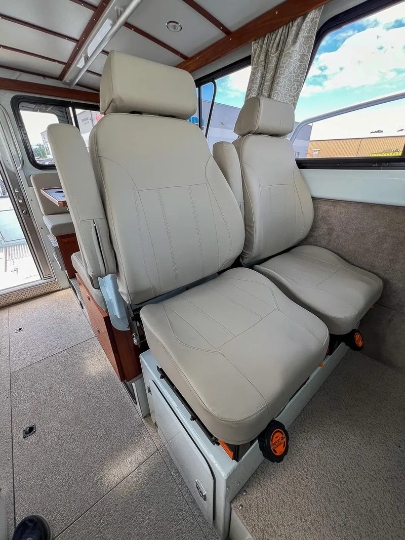Slide: The Image of Interior seating of 2022 Hewescraft 290 Adventure boat with beige leather seats. - 12
