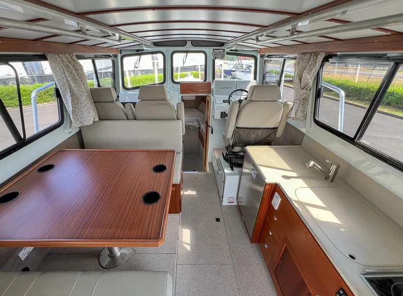 Slide: The Image of Interior of 2022 Hewescraft 290 Adventure boat with seating, table, and kitchenette. - 18
