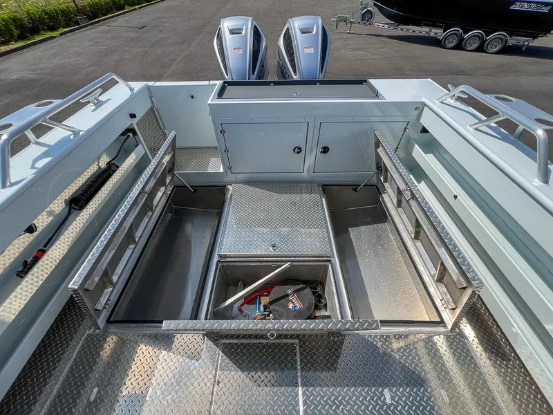 Slide: The Image of 2022 Hewescraft 290 Adventure boat with open storage compartments and dual outboard motors. - 20