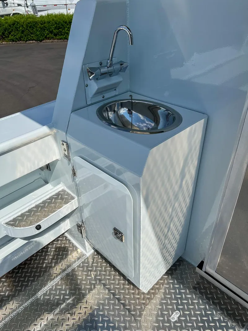 Slide: The Image of 2022 Hewescraft 290 Adventure boat sink and storage compartment. - 21