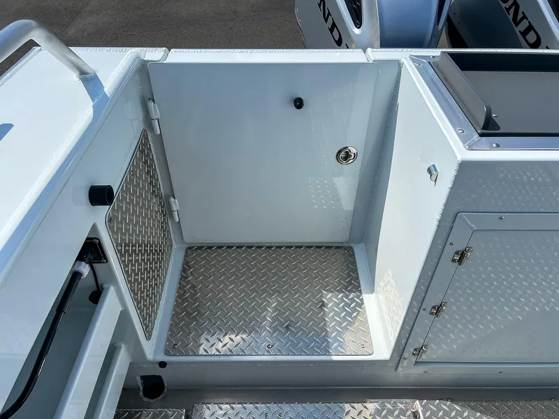 Slide: The Image of 2022 Hewescraft 290 Adventure boat interior with diamond plate flooring and storage compartments. - 23