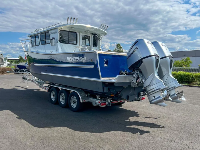 Slide: The Image of 2022 Hewescraft 290 Adventure boat with twin Honda outboard motors on a trailer. - 5