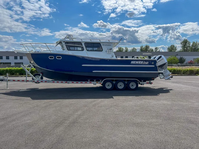Slide: The Image of 2022 Hewescraft 290 Adventure boat on a trailer under a blue sky. - 6