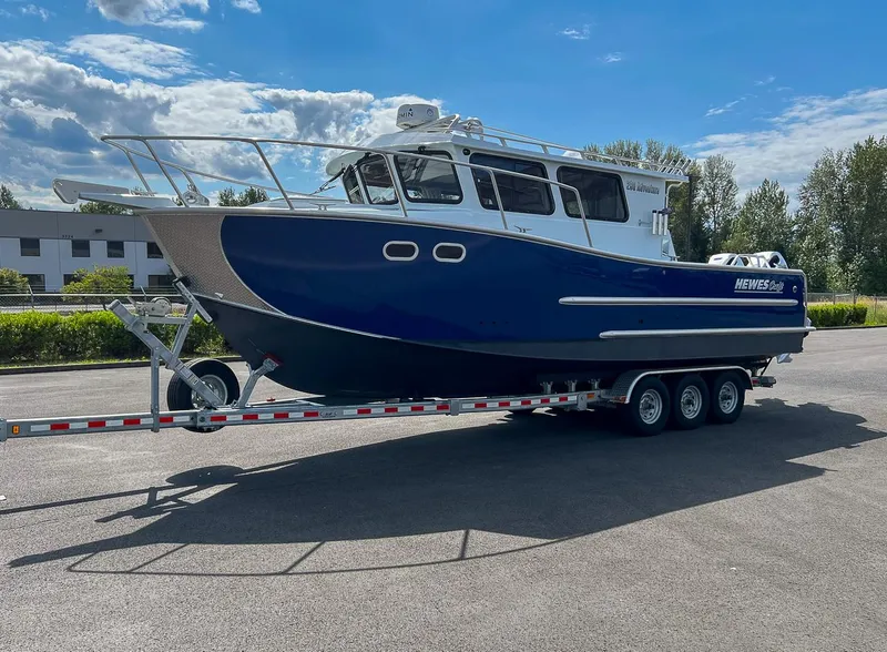 Slide: The Image of 2022 Hewescraft 290 Adventure boat on a trailer under a blue sky. - 7