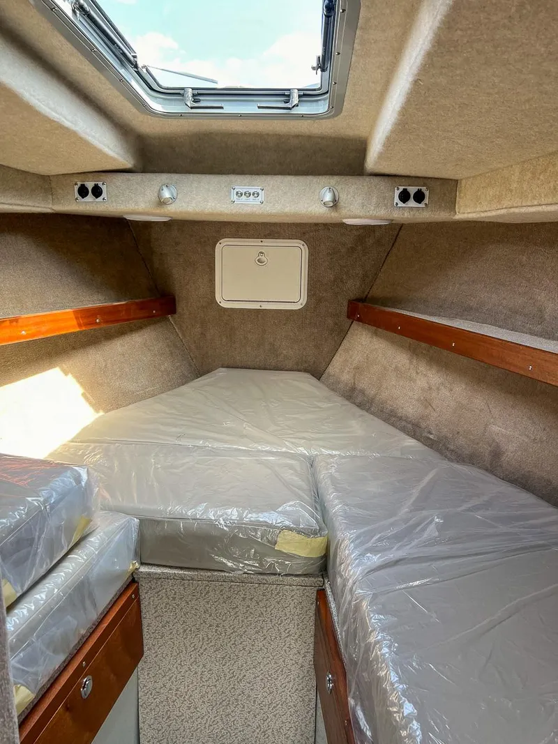 Slide: The Image of Interior cabin of 2022 Hewescraft 290 Adventure boat with bed and skylight. - 8