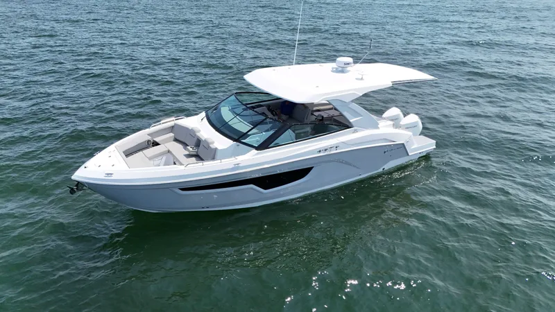 Slide: The Image of 2025 Cruisers Yachts 34 GLS Outboard on open water, sleek design, luxury boating. - 10